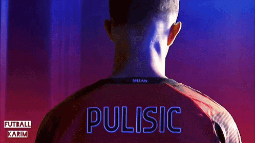 a man wearing a red milan shirt with the name pulisic on the back