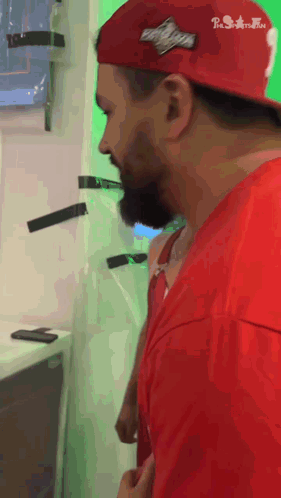 A Man Wearing A Red Shirt And A Red Hat With A Patch On It That Says Brooklyn GIF