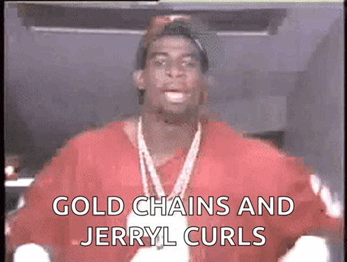 A Man Wearing A Red Shirt And Gold Chains Says Gold Chains And Jerry L Curls GIF