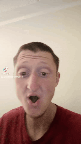 A Man Wearing A Red Shirt Is Making A Funny Face With Tiktok Written On The Bottom Right GIF