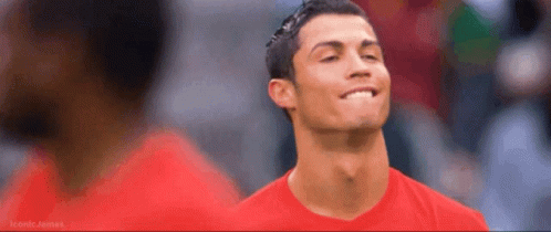 A Man Wearing A Red Shirt Is Smiling And Looking Up GIF