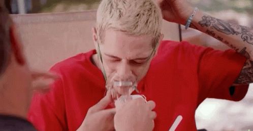 A Man Wearing A Red Shirt Is Using An Oxygen Mask GIF
