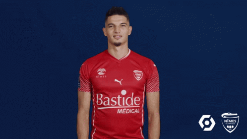 A Man Wearing A Red Shirt That Says Bastide Medical On It GIF