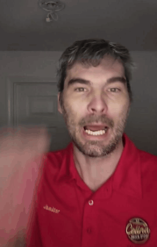 A Man Wearing A Red Shirt That Says Bitch On It GIF