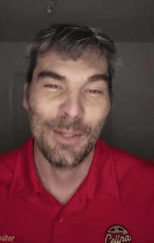 A Man Wearing A Red Shirt That Says Colin 'S On It GIF