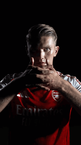 A Man Wearing A Red Shirt That Says Emirates GIF