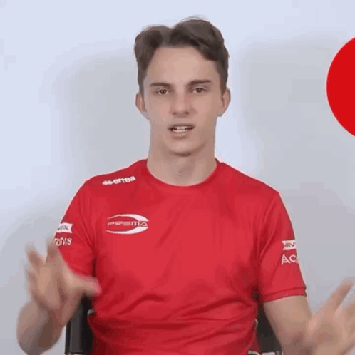a man wearing a red shirt that says errea