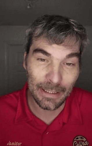 A Man Wearing A Red Shirt That Says " I Didn 'T Care " GIF