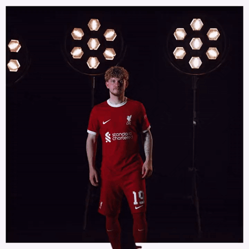 A Man Wearing A Red Shirt That Says Liverpool On It GIF
