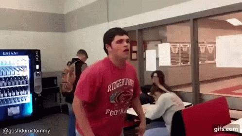 A Man Wearing A Red Shirt That Says Ridgerunner Football GIF