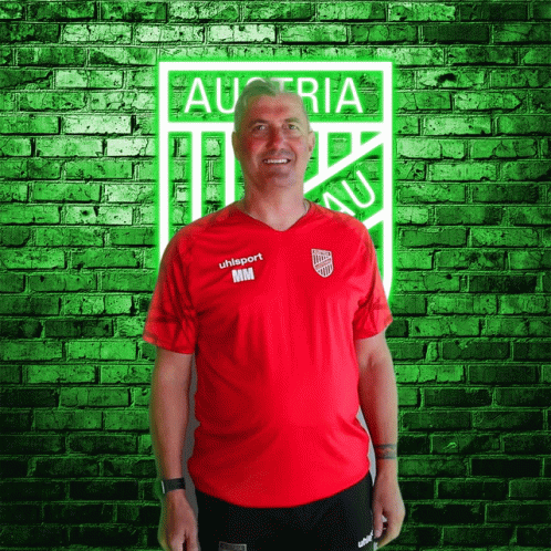 A Man Wearing A Red Shirt That Says Uhlsport GIF