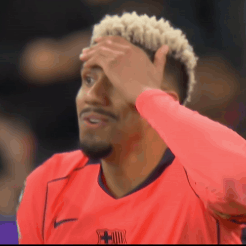 A Man Wearing A Red Shirt With A Fcb Logo On The Front GIF