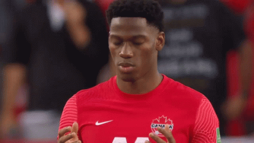 A Man Wearing A Red Shirt With A Maple Leaf On It GIF