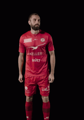 A Man Wearing A Red Shirt With The Number 23 On It GIF
