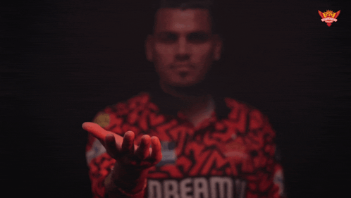 a man wearing a red shirt with the word dream on it