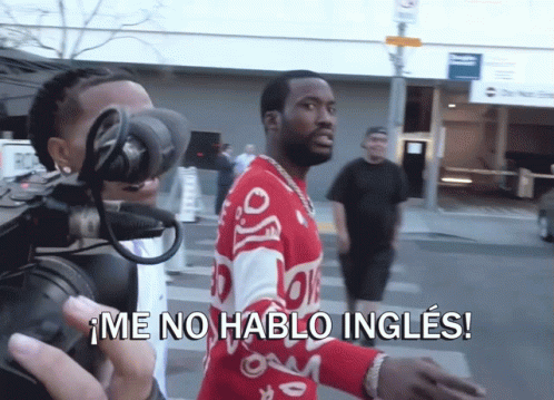 A Man Wearing A Red Sweater Is Being Filmed By A Camera And Says Me No Hablo Ingles GIF