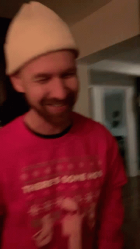 A Man Wearing A Red Sweater That Says There 'S Some Hos On It GIF