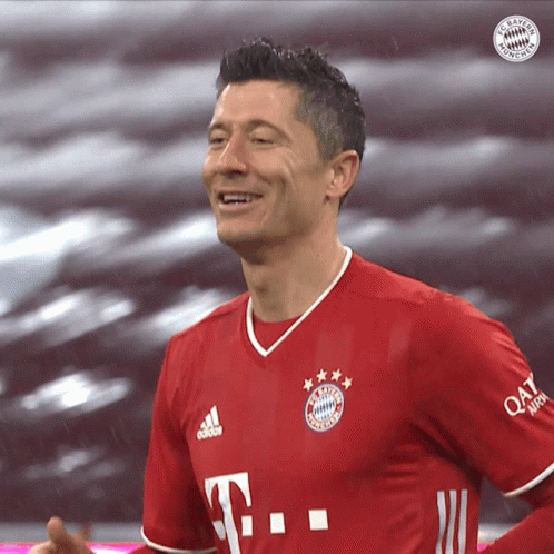 A Man Wearing A Red T-Mobile Jersey Smiles For The Camera GIF