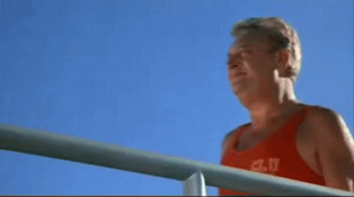 A Man Wearing A Red Tank Top That Says A.c.u.t. On It GIF