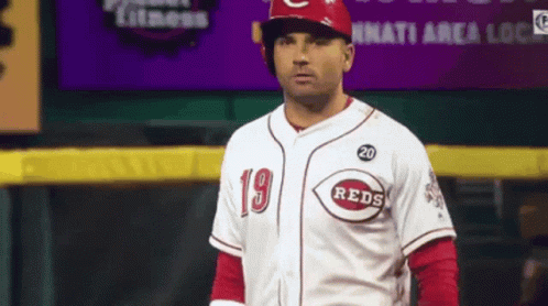 A Man Wearing A Reds Jersey With The Number 20 On The Front GIF