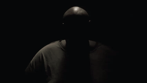 A Man Wearing A Reebok T-Shirt Is Looking At The Camera GIF