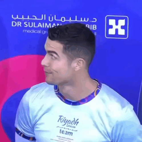 A Man Wearing A Riyadh Team Shirt Looks To The Side GIF