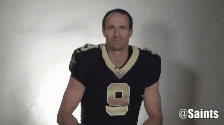 A Man Wearing A Saints Jersey With The Number 9 On It GIF