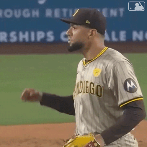 A Man Wearing A San Diego Baseball Uniform Is Standing On A Baseball Field GIF