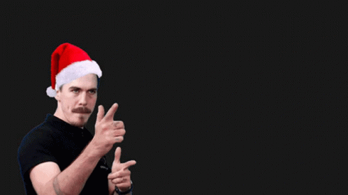 A Man Wearing A Santa Hat And A Shirt That Says Coach On It GIF