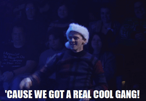 A Man Wearing A Santa Hat Is Standing In Front Of A Crowd And Says ' Cause We Got A Real Cool Gang ' GIF
