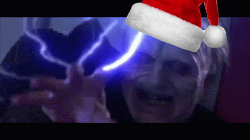 A Man Wearing A Santa Hat With A Light Behind Him GIF