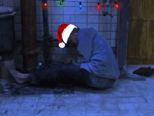 Man Wearing Santa Hat With White Ball GIF