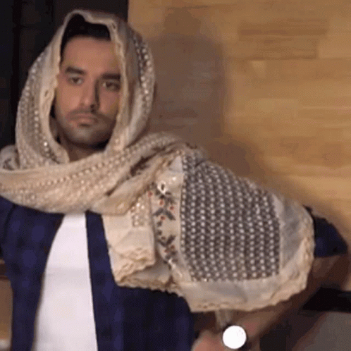 A Man Wearing A Scarf Around His Head And A Watch On His Wrist GIF