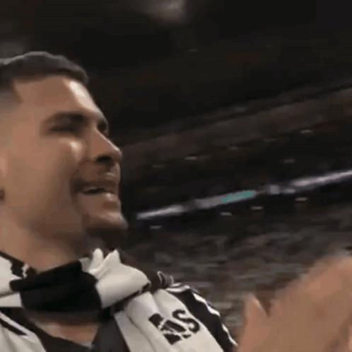 A Man Wearing A Scarf That Says Ras Is Clapping GIF