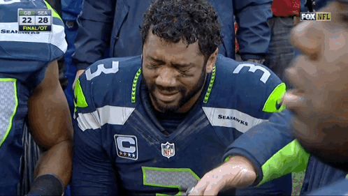 A Man Wearing A Seahawks Jersey Is Crying During A Game GIF