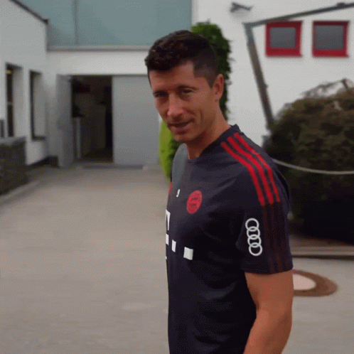 A Man Wearing A Shirt That Has The Word Audi On The Sleeve GIF