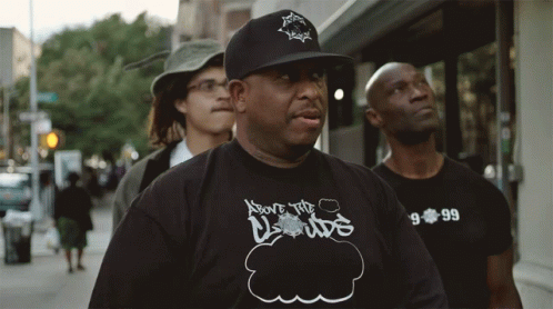 A Man Wearing A Shirt That Says Above The Clouds On It GIF