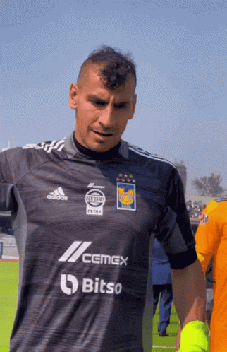 A Man Wearing A Shirt That Says Cemex Bitso On It GIF