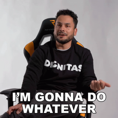 A Man Wearing A Shirt That Says Denitas Is Sitting In A Chair And Says I 'M Gonna Do Whatever GIF