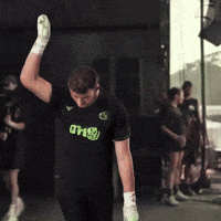 A Man Wearing A Shirt That Says Dhs Is Raising His Hand In The Air GIF