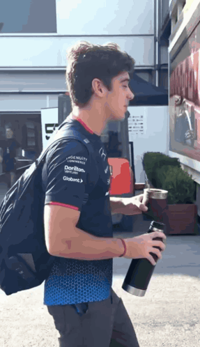 A Man Wearing A Shirt That Says ' Dorito ' On The Sleeve GIF