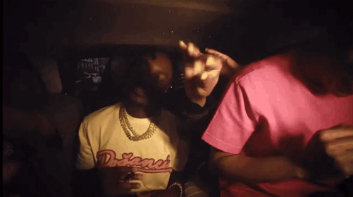 A Man Wearing A Shirt That Says Dreamer Is Sitting In A Car GIF