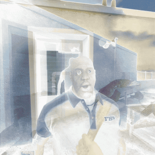A Man Wearing A Shirt That Says Fhs Is Standing In Front Of A Building GIF