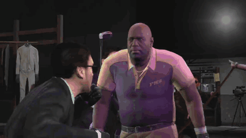 A Man Wearing A Shirt That Says Fhs Shakes Hands With Another Man In A Suit GIF