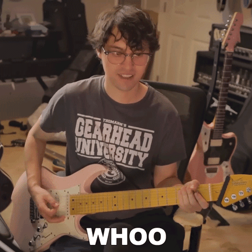 Man Playing Guitar Wearing Gearhead University Shirt GIF