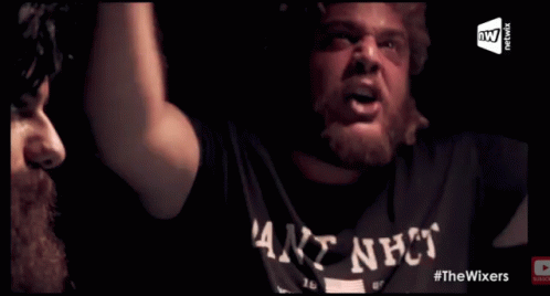 A Man Wearing A Shirt That Says ' Goat Shit ' On It Is Playing Poker GIF
