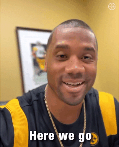 A Man Wearing A Shirt That Says Here We Go On It GIF