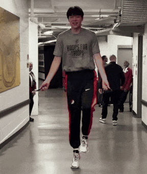 A Man Wearing A Shirt That Says Hoops For Troops Jumps A Jump Rope GIF