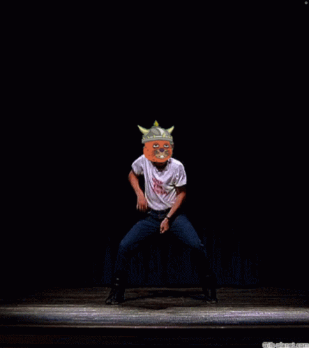 A Man Wearing A Shirt That Says ' It 'S A Pig ' On It Stands On A Stage GIF