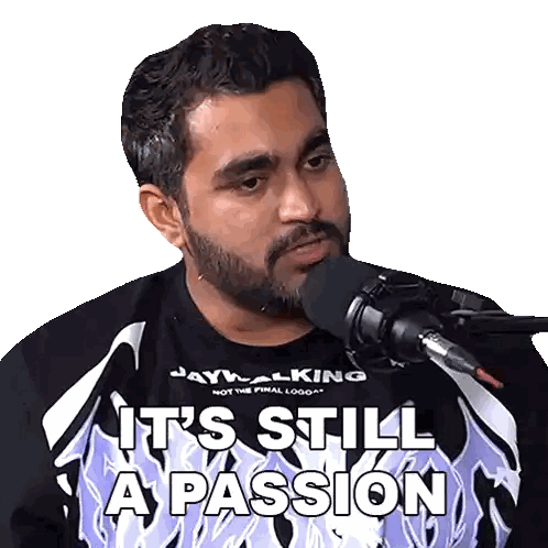 a man wearing a shirt that says " it 's still a passion " is talking into a microphone